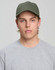 A green cotton twill unstructured cap worn by a young man in a grey t-shirt, featuring a logo.