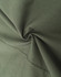 A close-up of dark green cotton blend fabric, showcasing its texture and softness. The material is smoothly folded.