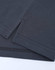 A close-up of a dark grey cotton/poly pique polo shirt, featuring seams and a small side split.