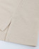 A close-up of a beige cotton/poly pique fabric, showcasing its texture and stitching details. It features a simple hemline.