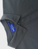 A grey polo shirt featuring a collar and a button, with a tag showing branding.