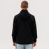 A black Core Weather Jacket viewed from the back, featuring a hood and a male model wearing it.