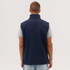 A navy softshell vest is displayed on a model from the back, featuring a high collar and no visible logos.