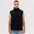 A black softshell vest on a model, paired with a light grey t-shirt, featuring a front zipper and a logo.