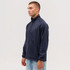 A navy Summit Bonded Jacket worn by a model, featuring a zip front and side pockets. The jacket includes a logo.