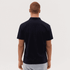 A man wearing a dark navy polo shirt, displayed from the back, with a simple design and a logo on the collar.