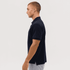 A navy polo shirt displayed on a model, featuring a classic collar and side slits for ease of movement.