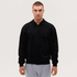 A black zip-up hooded sweatshirt on a model, featuring a front zipper and drawstring hood.