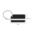 A square black aluminium luggage tag with a white stripe and a metal cable attachment. Dimensions included.