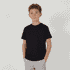 A youth essential tee in black, featuring a classic crew neck design. The model is standing with hands in pockets.