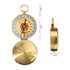 A brass compass with a decorative dial, featuring a magnifying glass and a ring for attachment, measuring 5cm by 2cm.