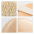 An exfoliating brush with soft massage nodules, featuring a beige handle and a textured bristle surface.