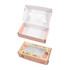 A medium pink gift box with a rectangular window, featuring a playful design and an inner compartment.