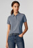 A women's short sleeve polo in light blue, featuring a collar and a logo, paired with jeans.