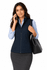 A woman wearing a navy vest, holding a handbag and talking on the phone, paired with a light blue shirt and skirt.
