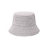 A grey dual-material reversible bucket hat with a textured finish and a wide brim. It features a logo.