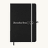 A black A5 notebook with an elastic closure and a logo on the front, featuring a grey band and bookmark.