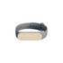 A grey wristband with a cream-coloured oval section, featuring a logo on the front.
