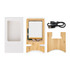 A bamboo charging stand with a white charging pad, USB cable, and packaging box, all neatly arranged.