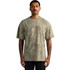A man wearing a heavy faded camo t-shirt in earthy tones of green and brown, featuring a logo.