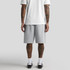 Grey shorts are displayed on a person from the back, wearing a white t-shirt and black shoes.