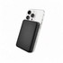 A black power bank is attached to the back of a smartphone, highlighting its sleek design. The product includes branding.