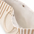 A tan and cream striped tote bag featuring a spacious interior and a snap closure.