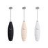 A milk frother in black, cream, and white, featuring a metallic whisk attachment and a logo.