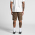 Canvas shorts in a light brown hue with cargo pockets, viewed from the back on a person wearing a white T-shirt.