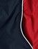 A close-up of a unisex jacket featuring a black exterior and a red lining with contrasting white piping.