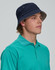 A beige bucket hat with a wide brim and ventilation holes, featuring a logo on the side.