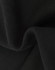 A close-up of soft, black fabric showcasing a textured surface, indicating a fleece material.