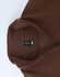 A brown polar fleece jumper featuring a 1/2 zip collar and an internal label. It has a smooth, soft texture.