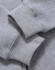 A grey full-zip fleecy hoodie featuring ribbed cuffs, highlighting texture and fabric detail. It has a logo.