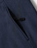 A close-up of a navy blue softshell hoodie featuring a zippered pocket. The fabric has a soft texture.