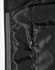 A close-up of a quilted jacket's interior lining in black, featuring a zippered pocket and smooth texture.