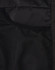 A close-up of the interior of a black insulated puffer jacket, featuring mesh pockets.