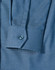 A close-up of a blue pin dot stretch long-sleeve shirt featuring a buttoned cuff and a patterned fabric.