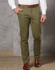 Men's Boston Chino Pants in olive green, featuring a slim fit and pockets, paired with a brown belt and shoes.