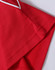 A red polo shirt with a textured fabric and white trim at the collar and sleeve edges. It has a logo.