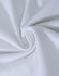 A close-up view of soft, white cotton fabric, showcasing a smooth and stretchy texture.