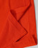 An orange Men's Truedry Pique Polo shirt, highlighting the fabric texture and seams. It features a logo.