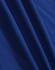 A close-up of deep blue fabric, showcasing a smooth texture with subtle woven patterns.