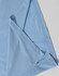 A light blue polo shirt featuring a folded sleeve, with a subtle branding logo.