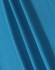 A close-up of blue fabric showcasing a textured weave, ideal for polo shirts. The fabric has a smooth appearance.