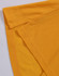 A close-up of a yellow polo shirt featuring folded sleeves and a logo.
