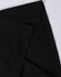 A black polo shirt featuring a classic collar and a logo, highlighting the fabric texture and stitching details.