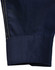 A close-up of a navy long-sleeve shirt featuring a yellow stitched cuff and a logo.