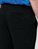 Black poly/cotton terry sweat pants with a pocket, featured on a model's side view.