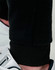 Black poly/cotton terry sweat pants with a fitted cuff, paired with sporty footwear.
